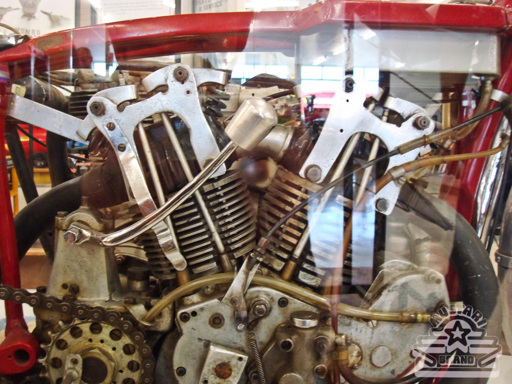 Burt's original race bike motor in frame and behind glass